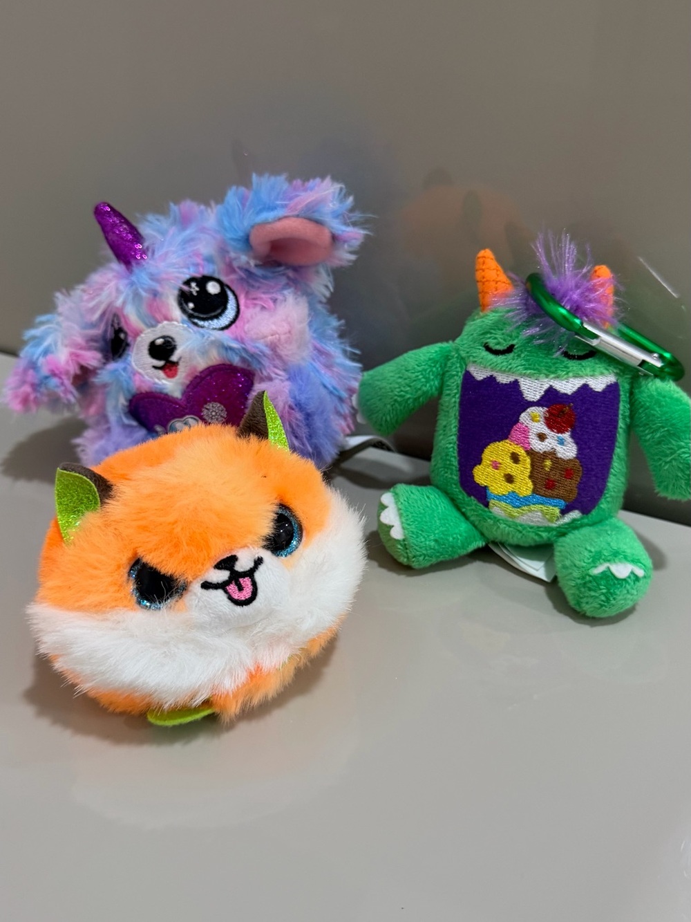 Plush Mini Keychain Trio in Orange, Purple, and Green - Cute Animal Characters.